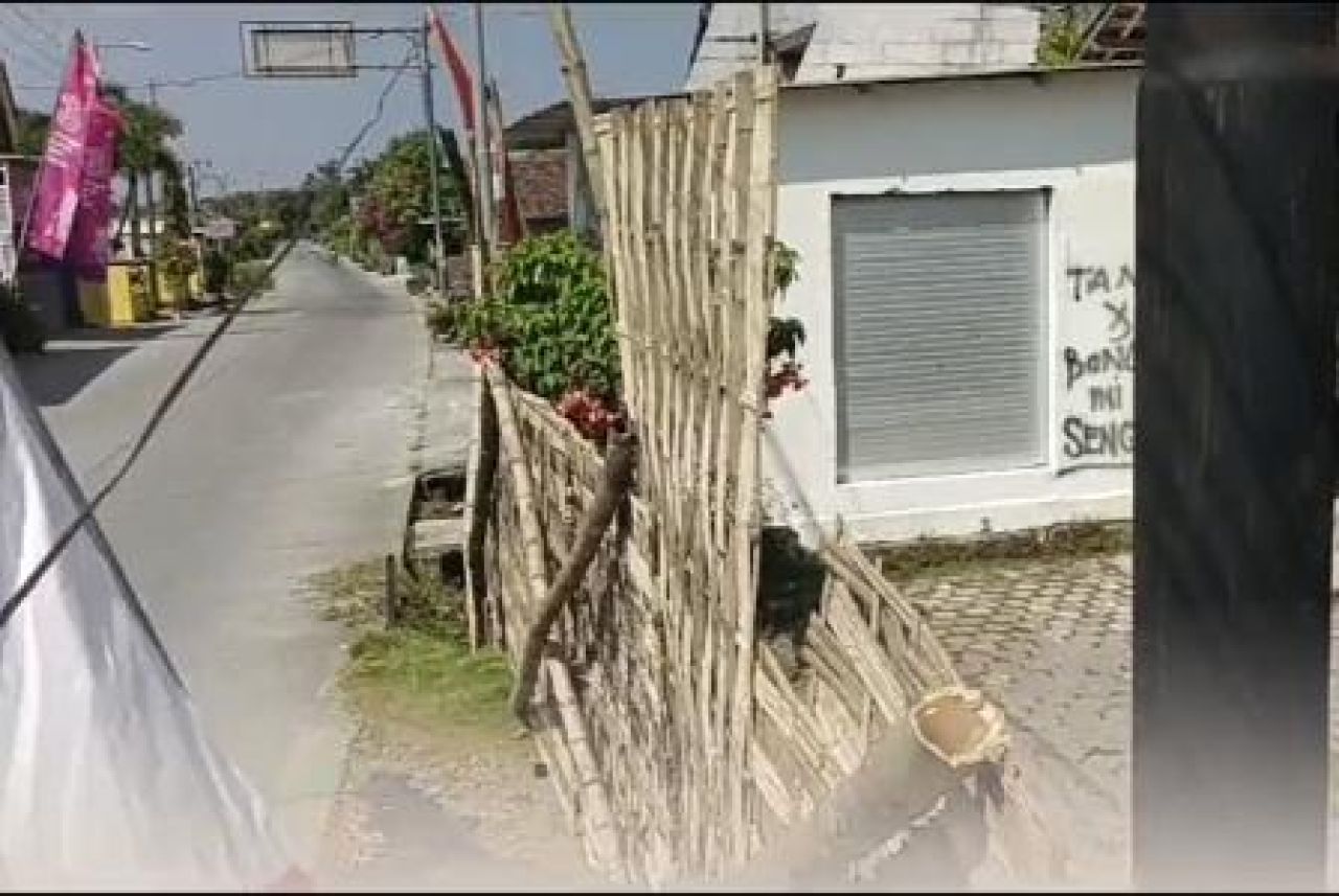 Akses keluar masuk rumah Yayuk disekat anyaman bambu