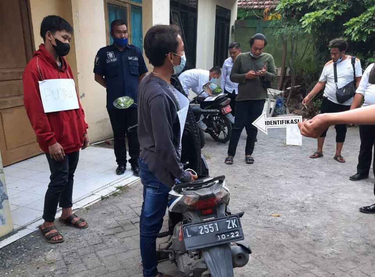 Rino Putra Firmansyah (pakai jaket hoodie dan pegang motor) saat reka adegan oleh Polres Gresik atas kematian Saputra
